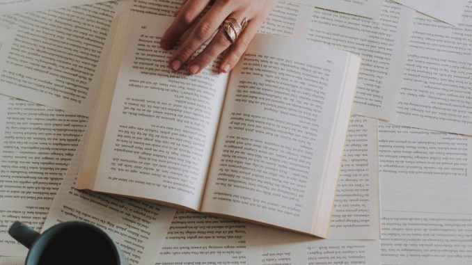flat lay photography of an open book beside coffee mug