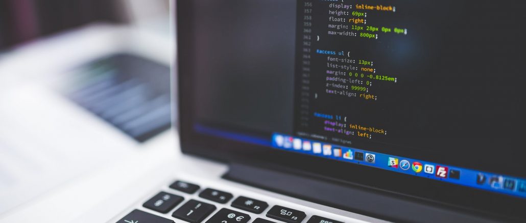 gray laptop computer showing html codes in shallow focus photography