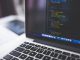 gray laptop computer showing html codes in shallow focus photography