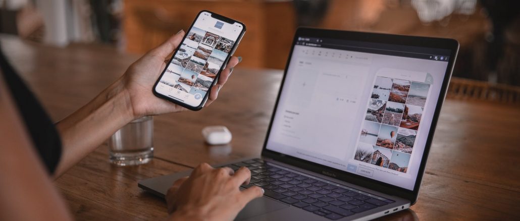 woman using smartphone and laptop