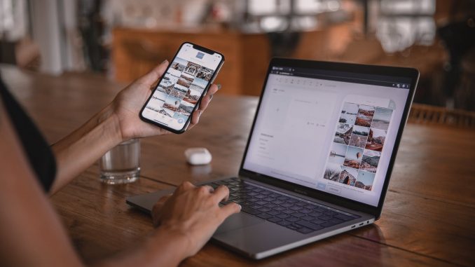 woman using smartphone and laptop